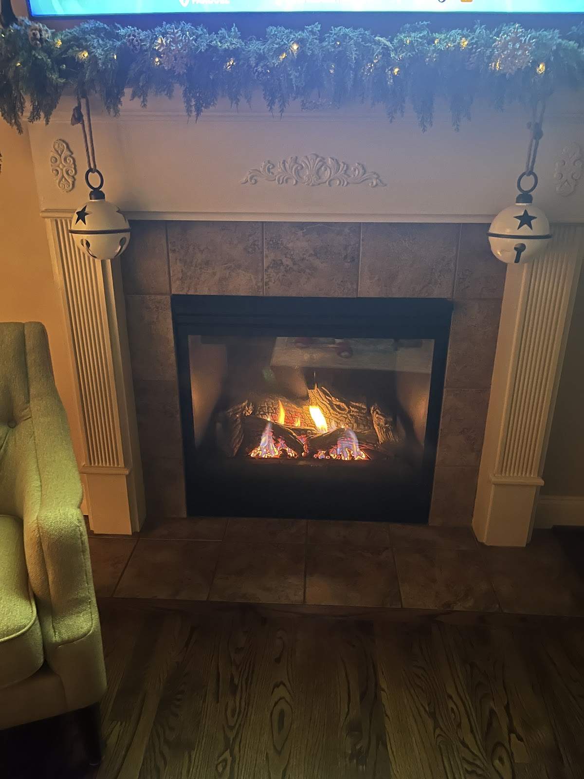 Gas fireplace with decorative logs, holiday mantel