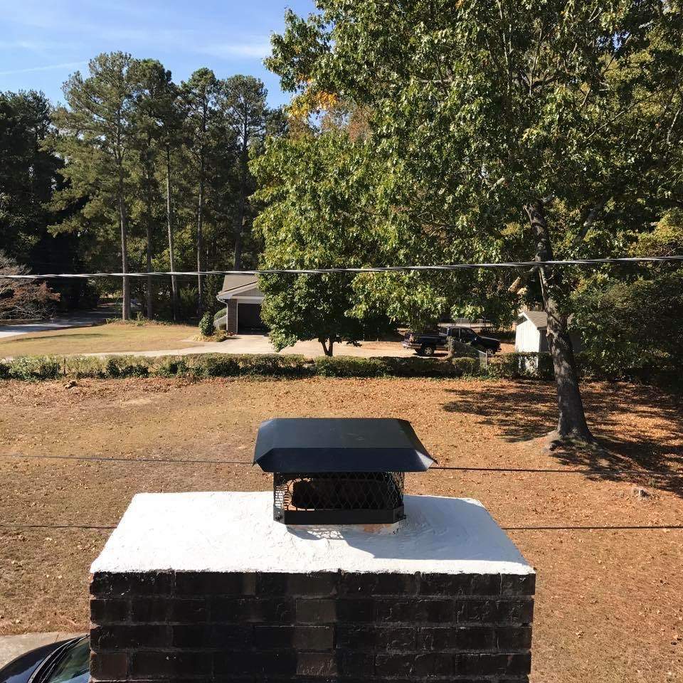 Single-flue chimney cap installed on exterior chimney